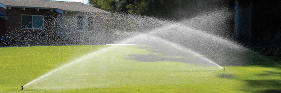 Toro rotors watering a residential lawn