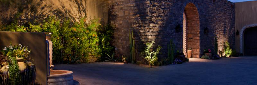 Landscape lighting showcasing a stone courtyard